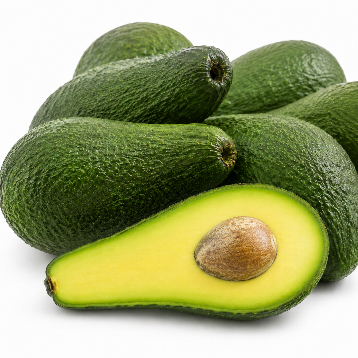 Whole elongated green Pinkerton avocados with one halved fruit showing thick yellow-green flesh and a characteristically small seed.
