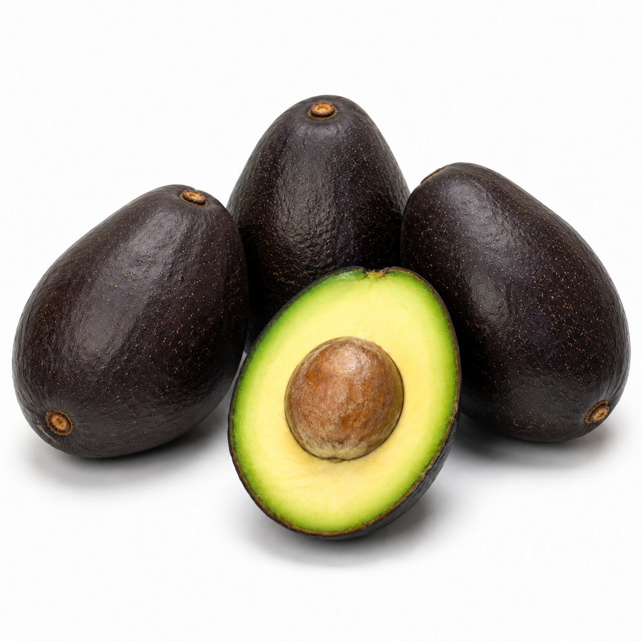 Whole dark-purple Stuart avocados with one halved fruit showing yellow-green flesh and a small tan seed.